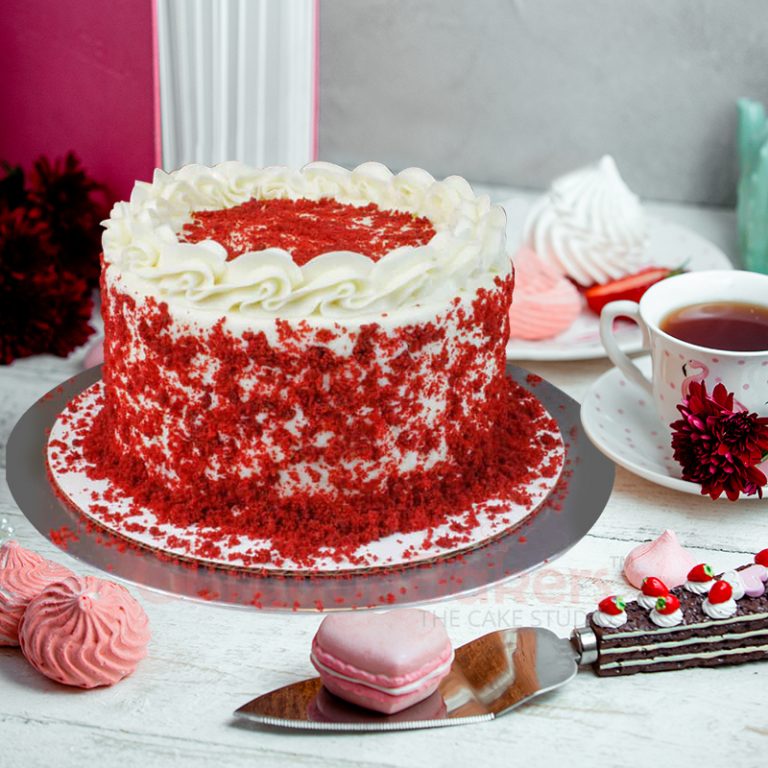 Traditional red velvet cake with a smooth cream cheese frosting and red crumb coat.