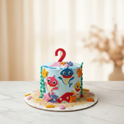 A vibrant Baby Shark cake decorated with colorful edible elements