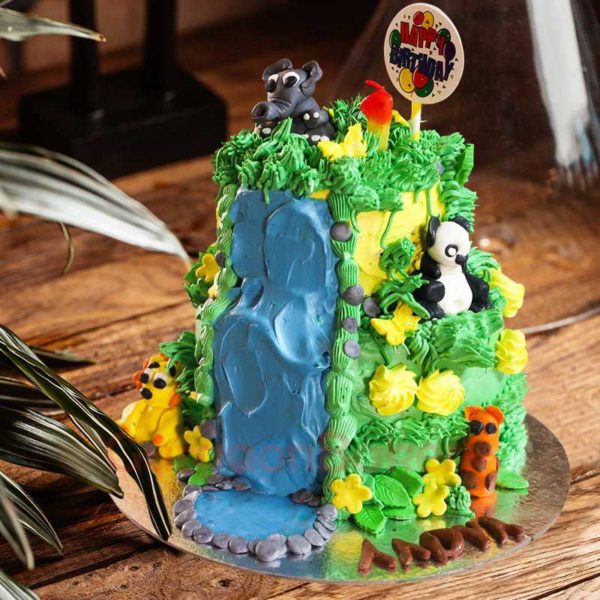 Fun jungle-inspired children's birthday cake with edible animal figurines and waterfall icing.