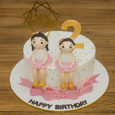 A beautifully designed Ballerina Delight Cake with two fondant ballerina figurines for a birthday celebration