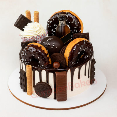 Delightful chocolate cake with donuts, cupcakes, and chocolate toppings