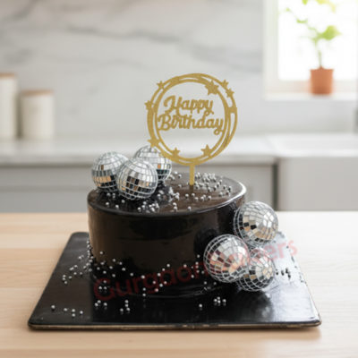 Delicious chocolate birthday cake decorated with disco balls