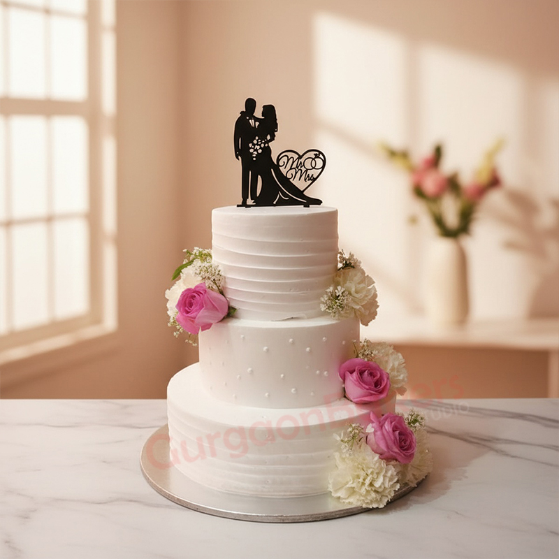 elegant-three-tier-wedding-cake Elegant three-tier wedding cake with flowers and black couple topper