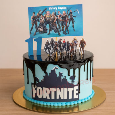 A vibrant Fortnite cake with characters and a 'Victory Royale!' topper for an 11-year-old birthday party