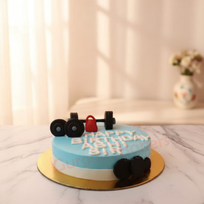 Gym theme cake with dumbbells and kettlebells decorations