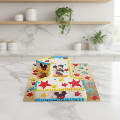 Mickey Mouse themed first birthday cake with stars and colorful frosting
