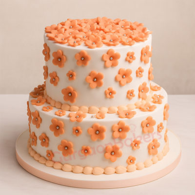 Elegant two-tiered wedding cake decorated with peach flowers