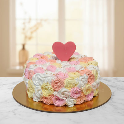 Rosy Delight Cake with pastel rose frosting and a heart topper