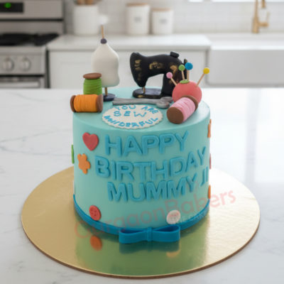 A colorful birthday cake for mom featuring sewing-themed decorations and a blue frosting