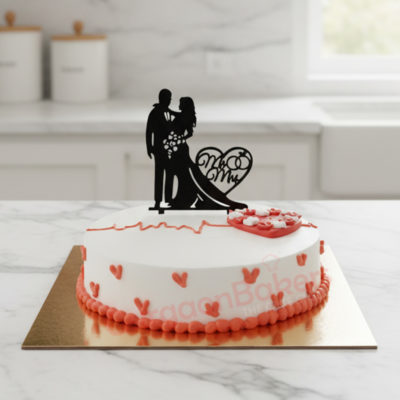 A beautifully decorated small wedding cake with a couple silhouette and heart motifs