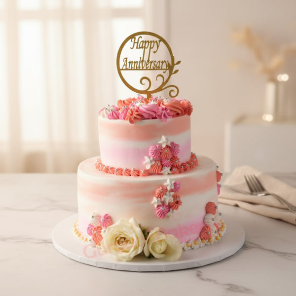 Delightful 2 tier anniversary cake with flowers and a 'Happy Anniversary' topper