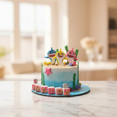 Colorful Baby Shark cake with fondant decorations featuring Baby Shark characters.