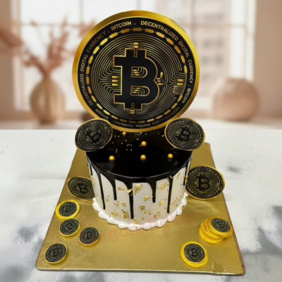 A stylish Bitcoin-themed cake with black and gold detailing