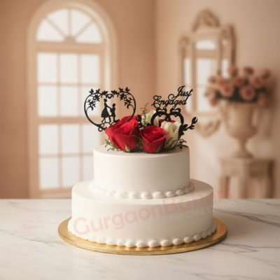 A beautifully designed engagement anniversary cake with red roses and decorative elements