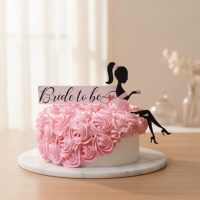 Stunning Bride to Be cake with pink frosting and topper