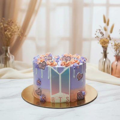 BTS-themed celebration cake with colorful icing and heart details