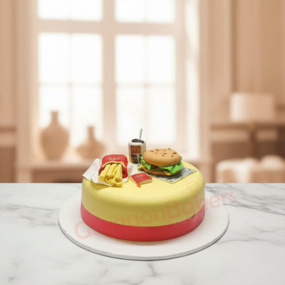 A vibrant custom cake designed to look like a hamburger with fries and a drink.