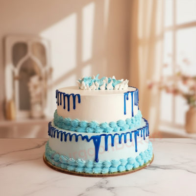 Elegant two-tier corporate celebration cake with blue frosting and white decorations