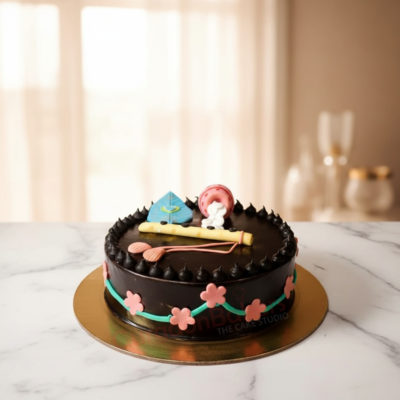 Customized Janmashtami cake with flute and peacock feather decorations