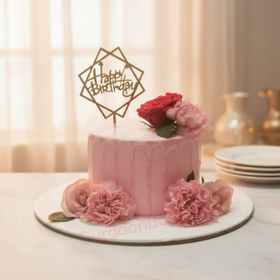 Elegant Pink Birthday Cake adorned with fresh flowers