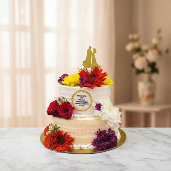 Elegant wedding cake adorned with flowers and a couple cake topper