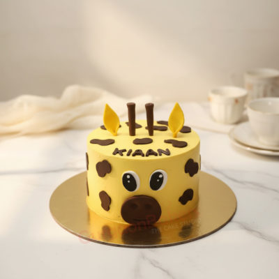Cute giraffe cake with yellow frosting and chocolate spots