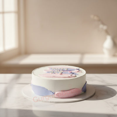 A beautiful pastel colour cake with soft pink and blue frosting on a marbled surface.