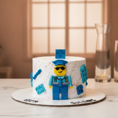 Colorful policeman birthday cake with a figurine