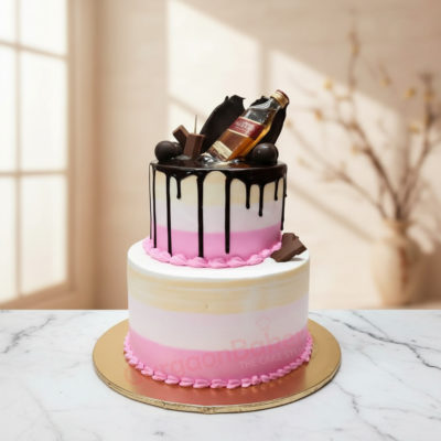 A beautifully designed tier alcohol birthday cake with a bottle and chocolate decorations.