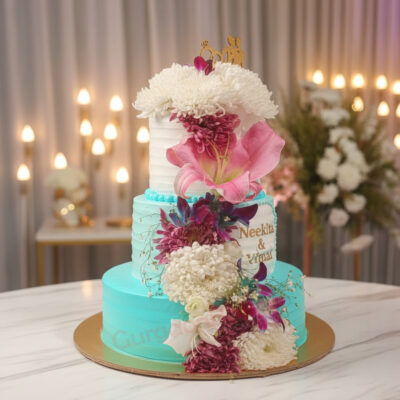 Stunning wedding cake adorned with pink lilies and white flowers