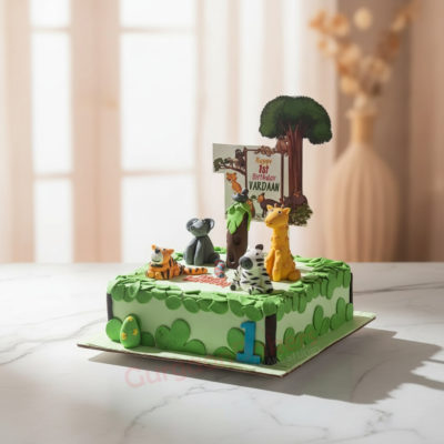 Colorful jungle-themed birthday cake with fondant animals