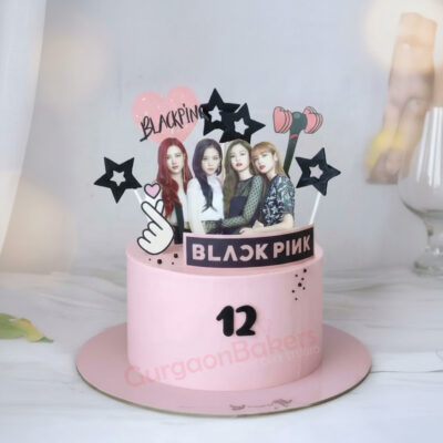 A beautiful Black Pink themed cake with musical decorations and a 12th birthday indication