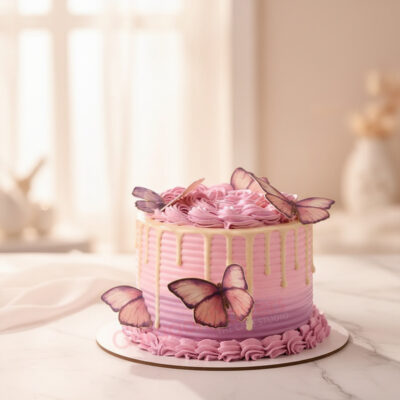 Butterfly theme cake with pink and purple layers adorned with golden balls and butterflies.