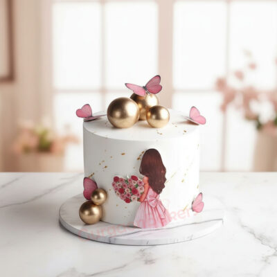 A beautifully designed butterfly cake with pink butterflies and gold accents.