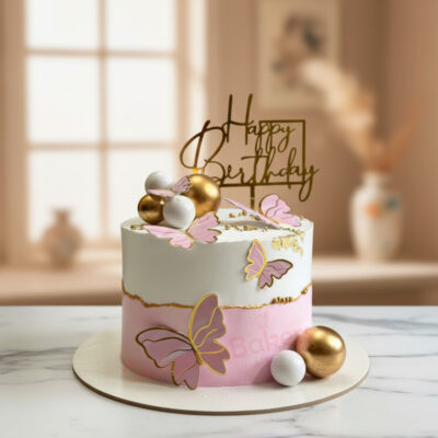 Beautiful pink butterfly cake with golden accents and birthday topper