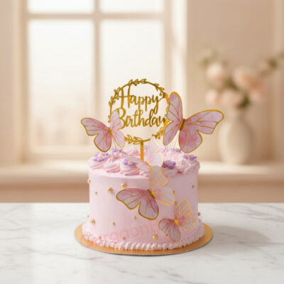 A beautiful pink butterfly cake adorned with edible butterflies and golden sprinkles