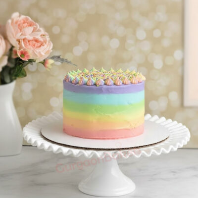 Colorful Rainbow Delight Cake on a white cake stand