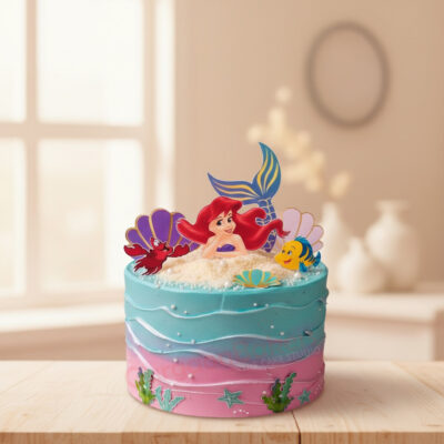 Colorful mermaid cake with Ariel figurine and ocean details
