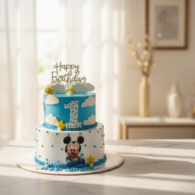 A beautifully designed 1st birthday Mickey Mouse cake with blue and white colors, topped with clouds and stars.