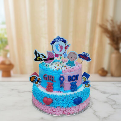 Vibrant baby shower theme cake with pink and blue frosting and playful decorations.
