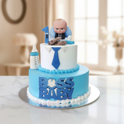 Two-tiered Boss Baby themed cake for kids featuring a figurine of Boss Baby, a bottle and cookies.