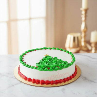 Beautifully decorated Christmas cake with green frosting in the shape of a Christmas tree.