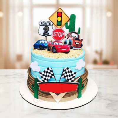 Colorful birthday car cake featuring racing themes and characters.