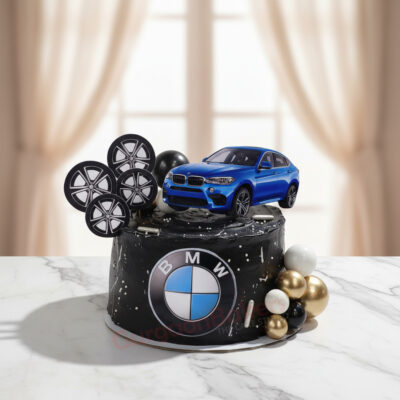 BMW-themed birthday cake with a blue car and decorative wheels