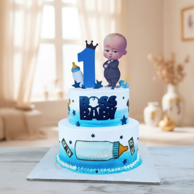 Two-tier Boss Baby birthday cake with blue and black design.