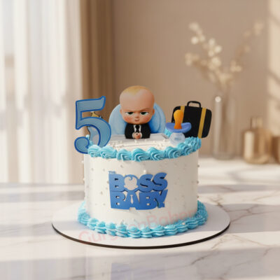A colorful Boss Baby themed birthday cake with blue frosting and edible decorations.
