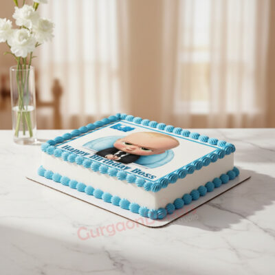 Boss Baby themed cake with blue frosting and character image.