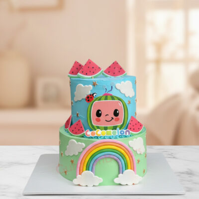 Colorful Cocomelon themed birthday cake with rainbow and watermelon decorations