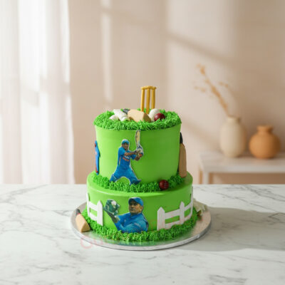 Two-tier cricket theme cake with green frosting and cricket decorations
