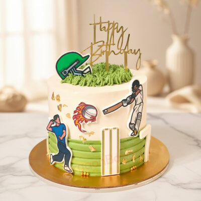 A cricket sports cake decorated with fondant figures and grass icing, perfect for birthday celebrations